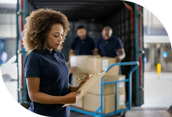 Warehouse worker with tablet managing inventory and delivery operations.