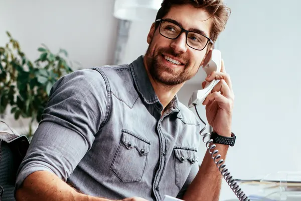 Man talking on an office phone line