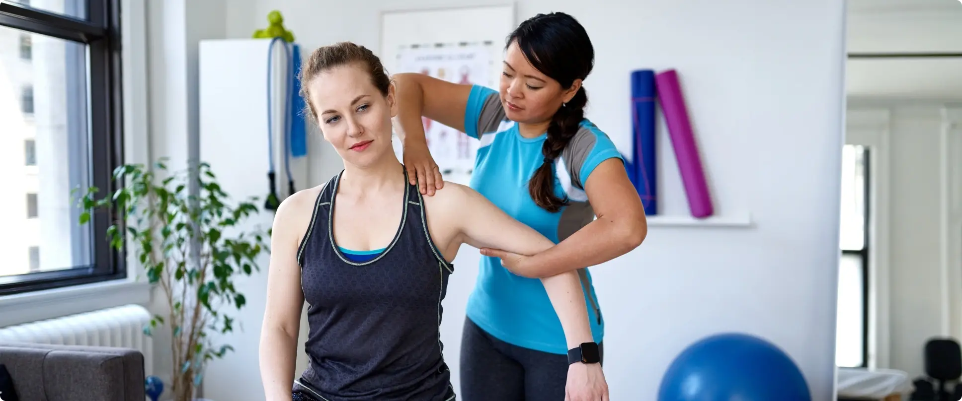 a chiropractor working with her female patient.