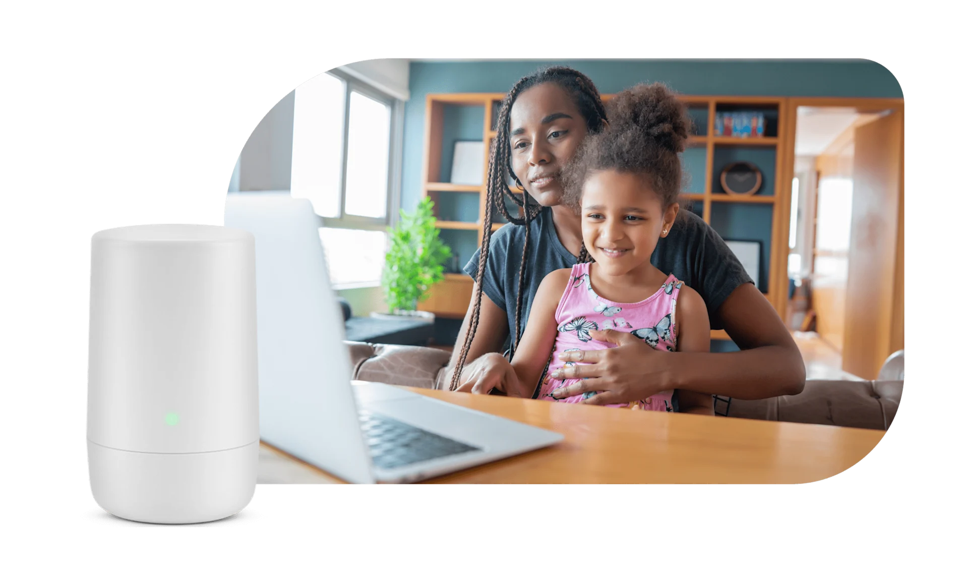 A mother and daughter viewing a laptop. To the left is a TELUS WiFi modem.