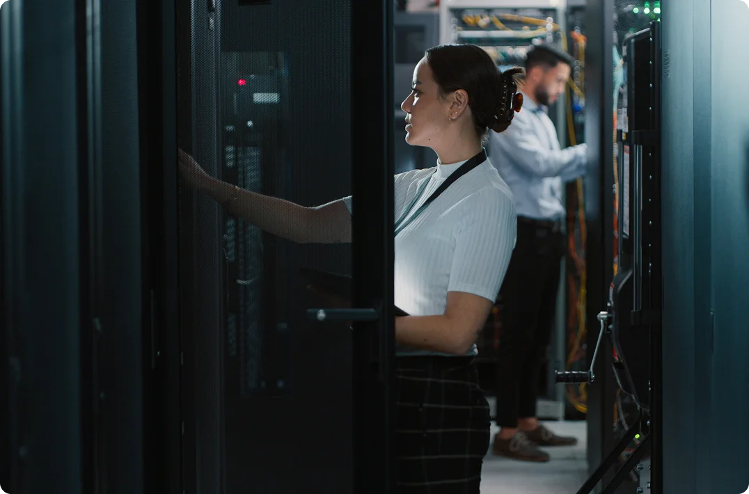 IT technician accessing server equipment in a data center.