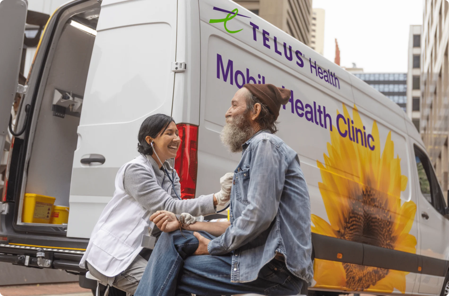 A TELUS Mobile Health Clinic team member attending to a patient.