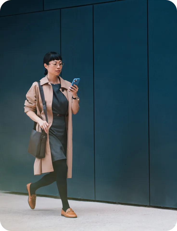 A women outside walking while on her phone