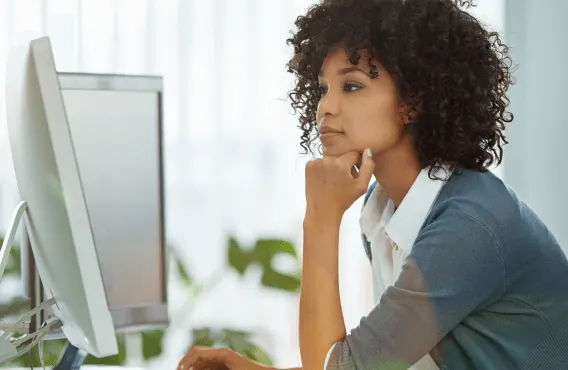 An HR professional looks at her desktop computer screen