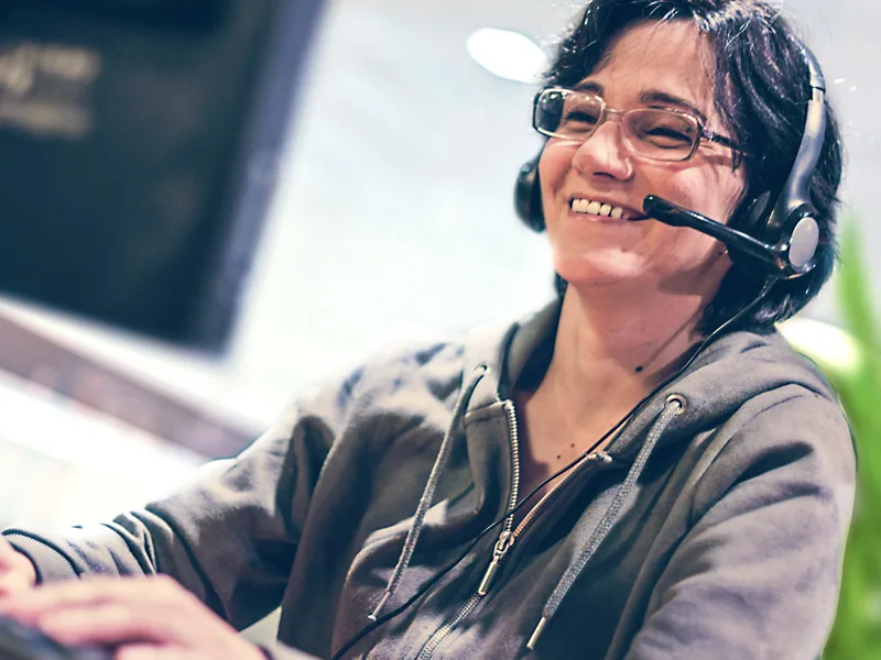 Smiling contact centre representative talking on a headset