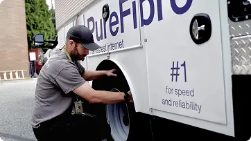 Technician performing vehicle maintenance inspection on fleet truck.