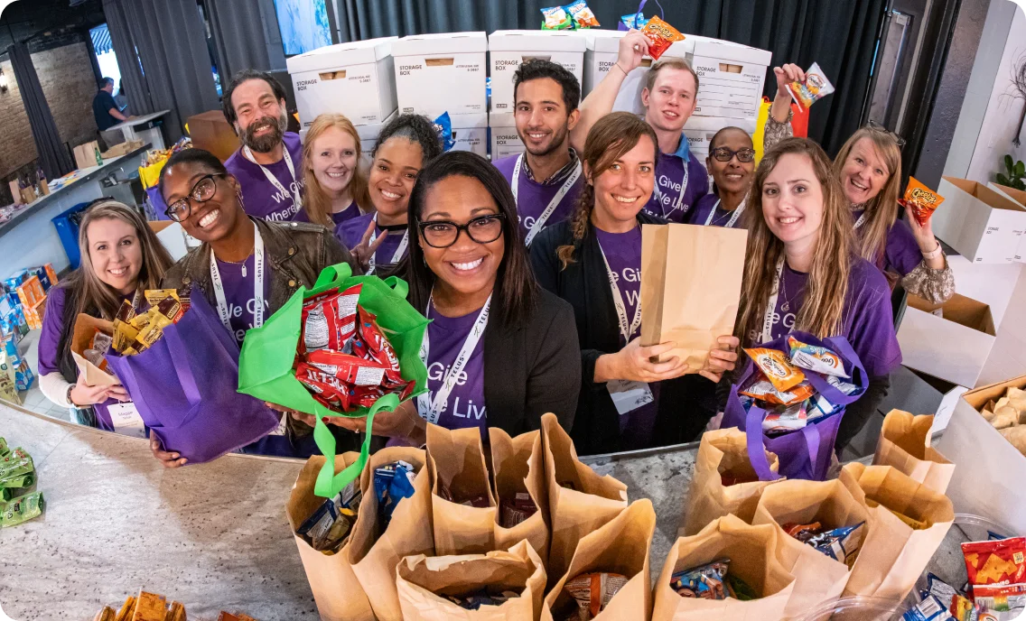 TELUS team members preparing food hampers during TELUS Days of Giving, our signature global volunteer movement. 