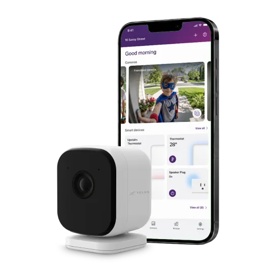 TELUS smart security camera next to a smartphone showing a live camera feed of a child in a costume on the app.