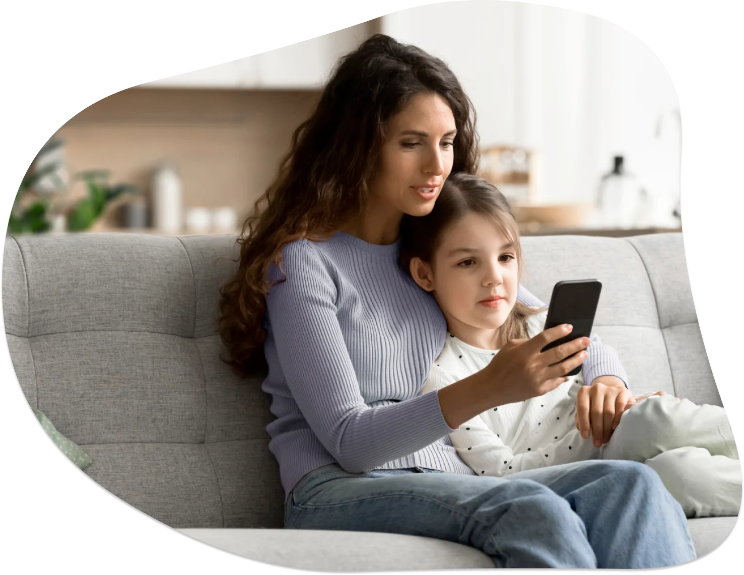 Young mom with her toddler, enjoying a phone chat