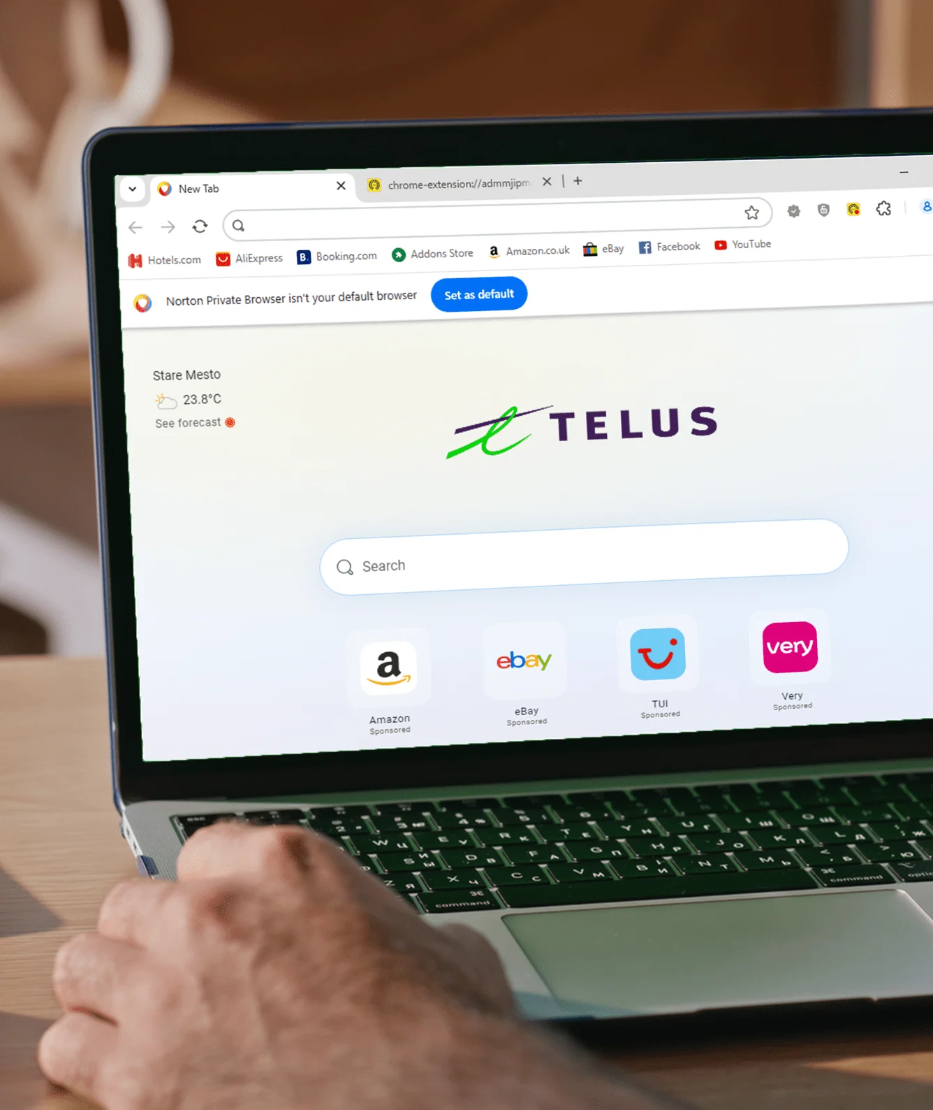 A laptop screen showing the TELUS logo.