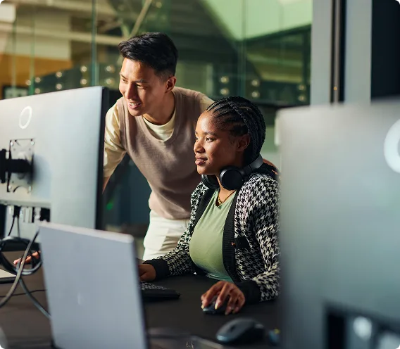 Business professionals collaborating on computer in modern office.
