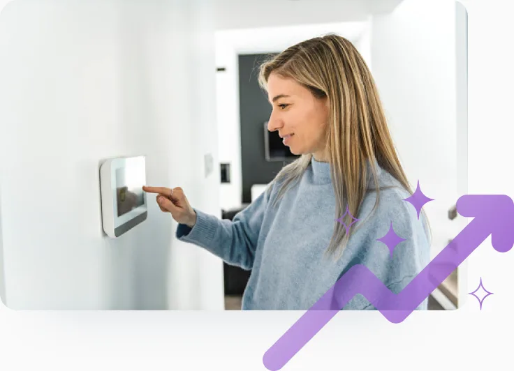 A woman adjusts a smart thermostat while participating in an energy savings event to earn TELUS Rewards. 