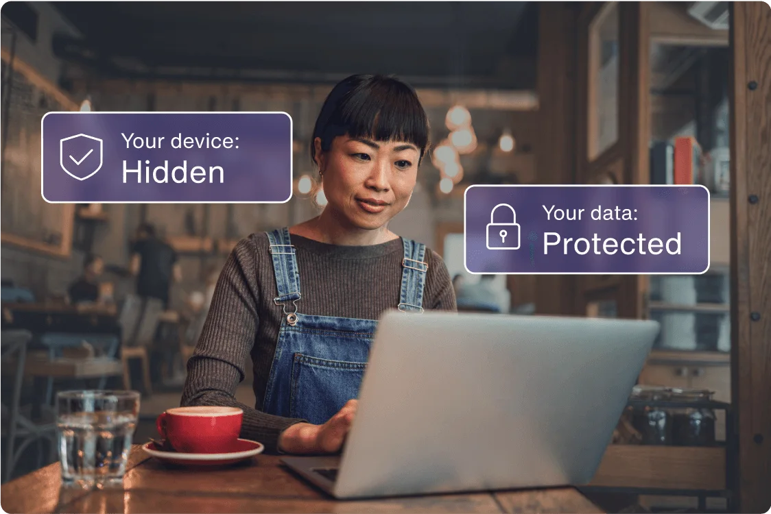 A person works at a coffee shop online, using their laptop. The message is: Your device is hidden and your data is protected.