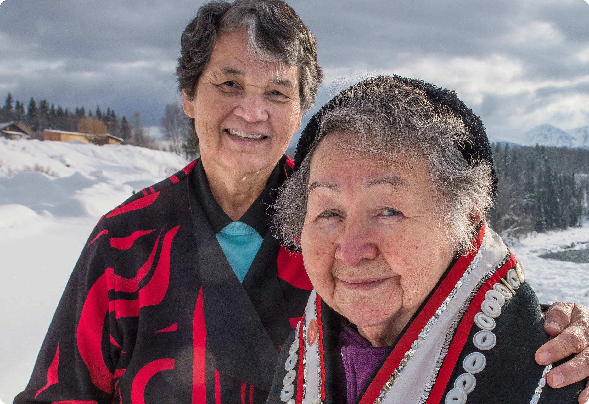Two Indigenous women smiling at the camera