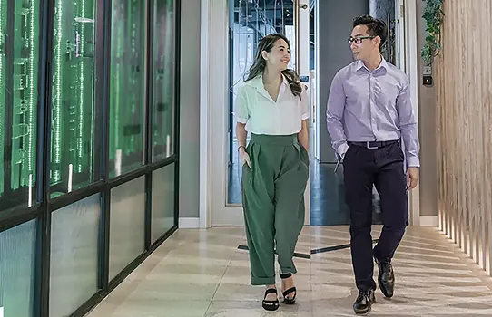 Two professionals walking in a modern office