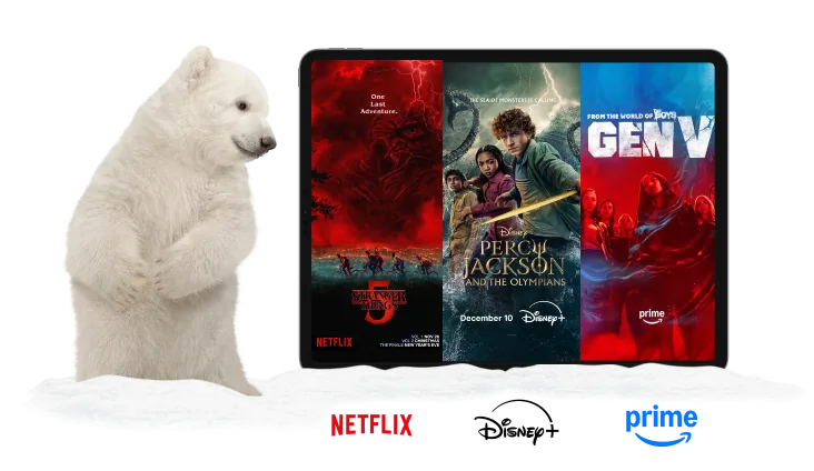 A polar bear standing next to a tablet. The tablet displays posters for Wednesday, The Lowdown and Gen V. Under the tablet are logos of Netflix, Disney+ and Amazon Prime.