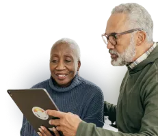 An older couple watching an Online Basics course on their tablet