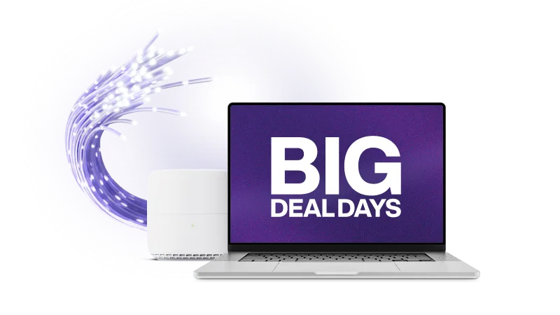 A TELUS modem next to a laptop. The laptop screen displays the text “Big Deal Days”.