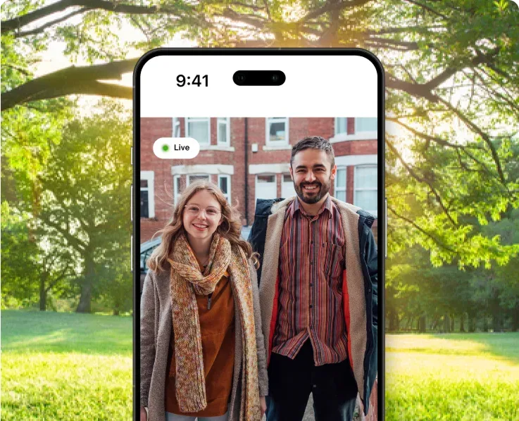 Smartphone displaying video call with couple outdoors