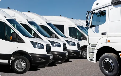 White commercial delivery trucks lined up in fleet parking area