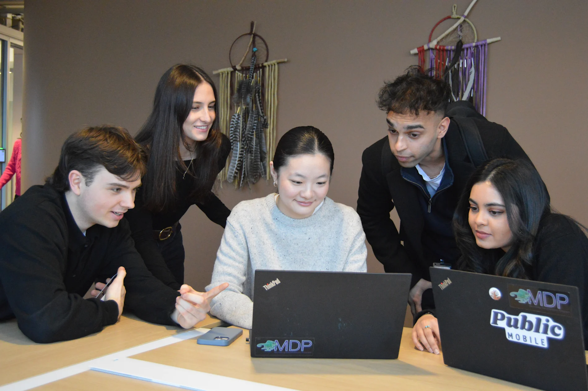 TELUS team members working together in the office