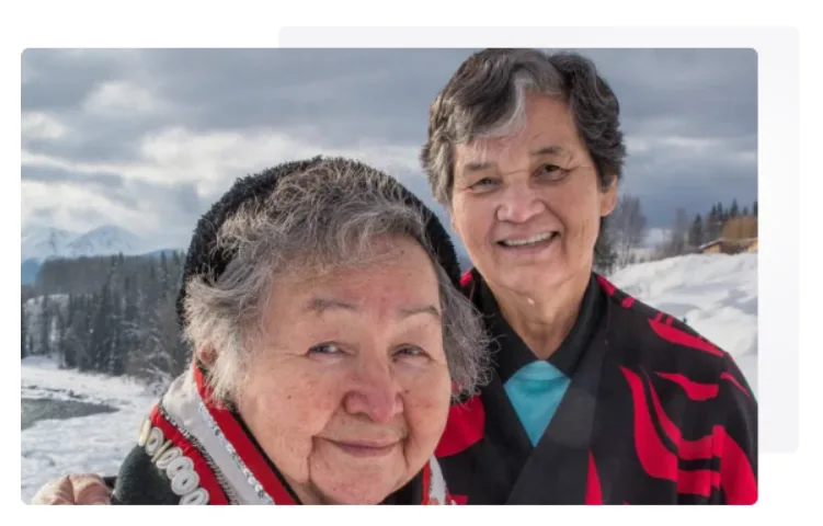 Two Indigenous women smiling at the camera