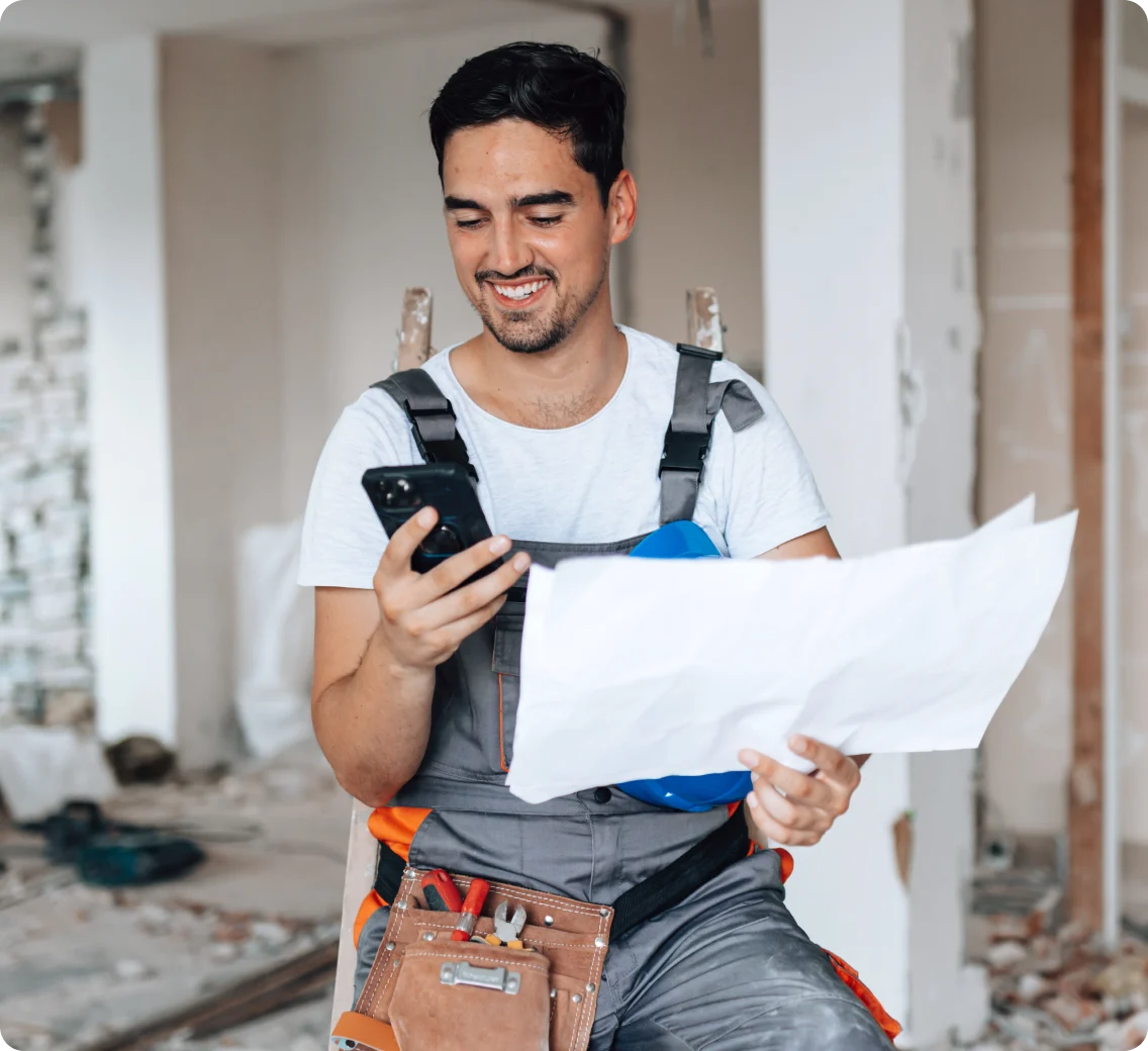 A man at a construction site on his tablet