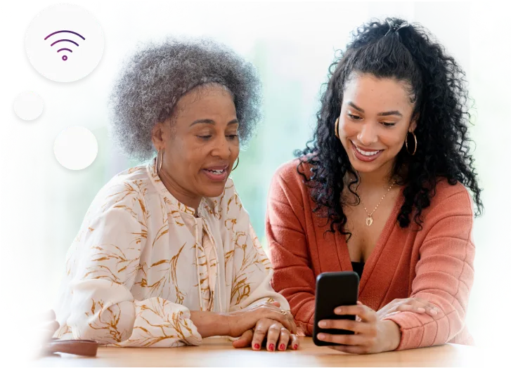 Deux femmes regardant un téléphone intelligent ensemble