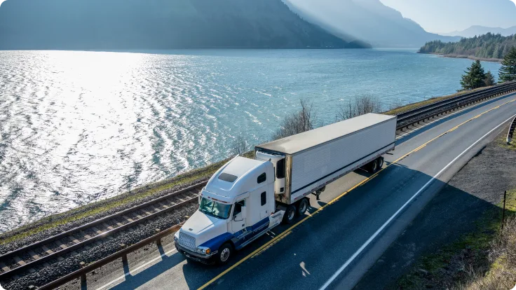 Transport truck driving on coastal highway