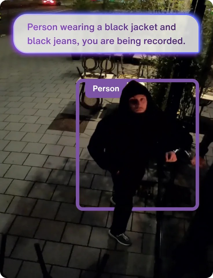 Security camera view detecting a person wearing a black jacket and jeans with AI identification overlay.