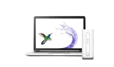 A laptop next to a TELUS modem. The laptop screen displays a hummingbird flying toward a fibre optic cable.