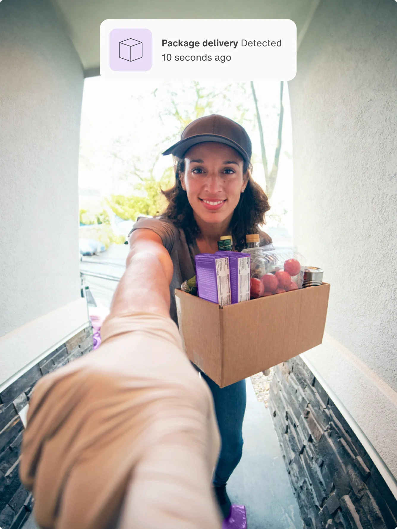 A view from the doorbell camera of a delivery person ringing the doorbell.