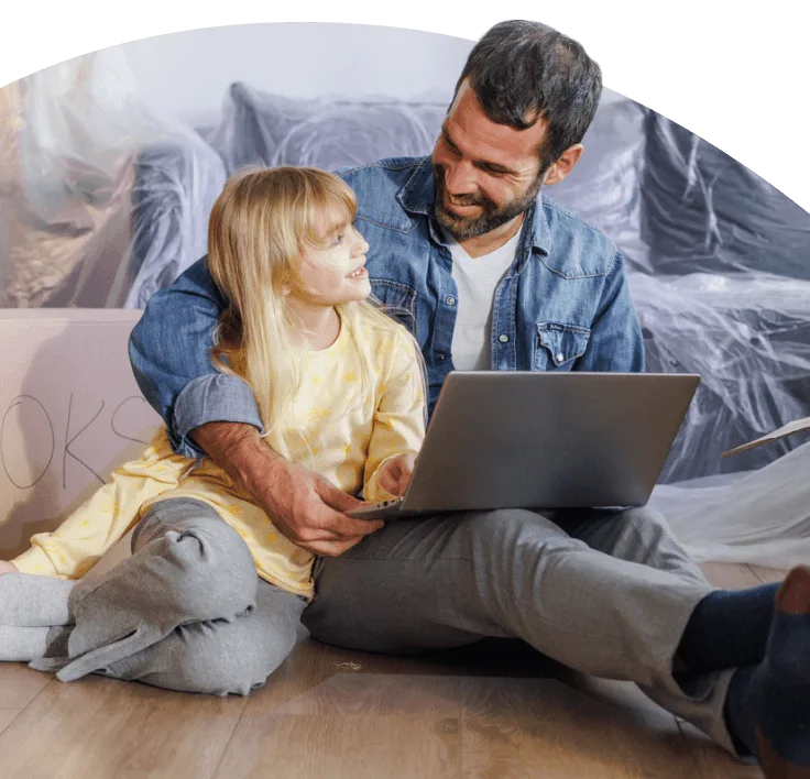 A father and daughter sitting together using a laptop.