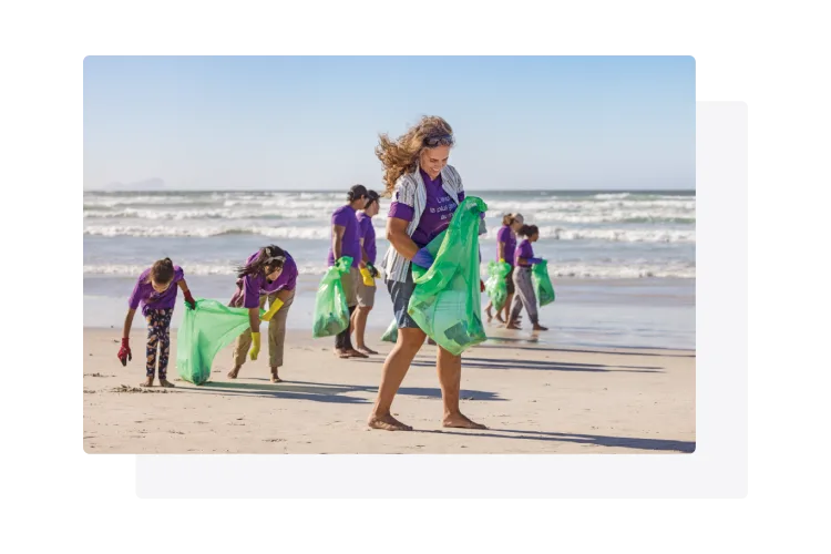 TELUS team members cleaning a shoreline.