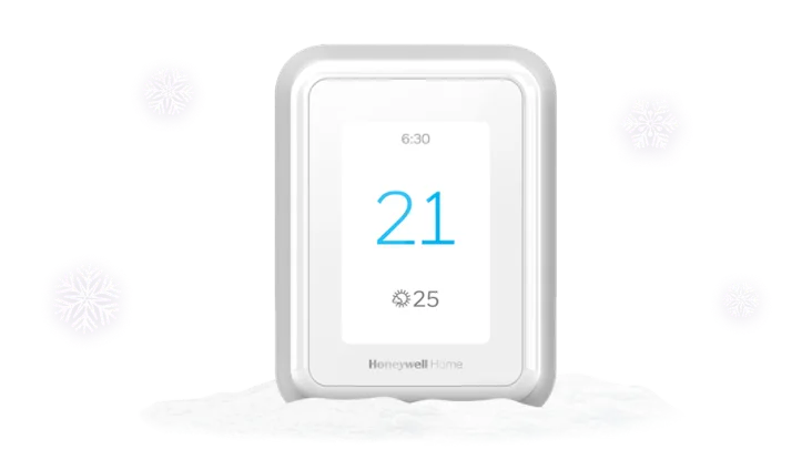 Image montrant un thermostat Honeywell T9 avec des flocons de neige qui tombent en arrière-plan.
