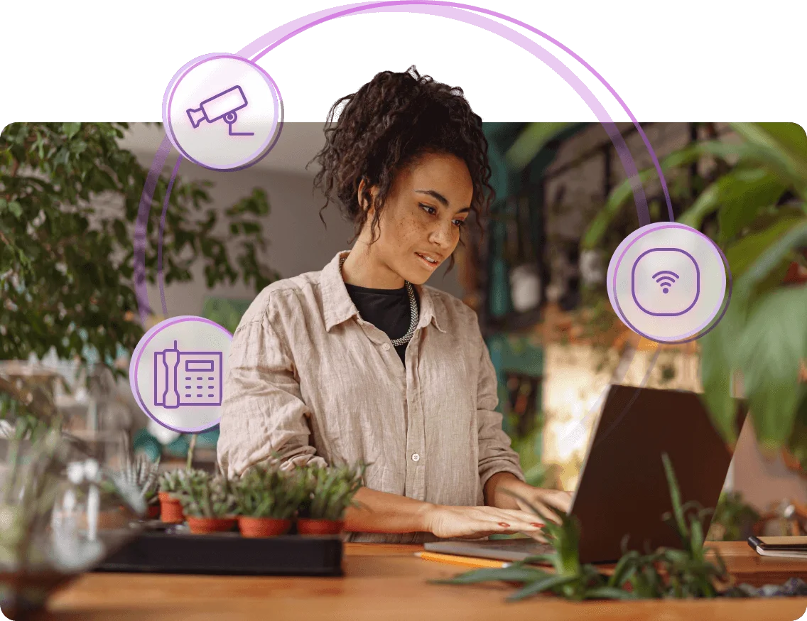 A woman with icons of a camera, wi-fi, and phone circulating around her