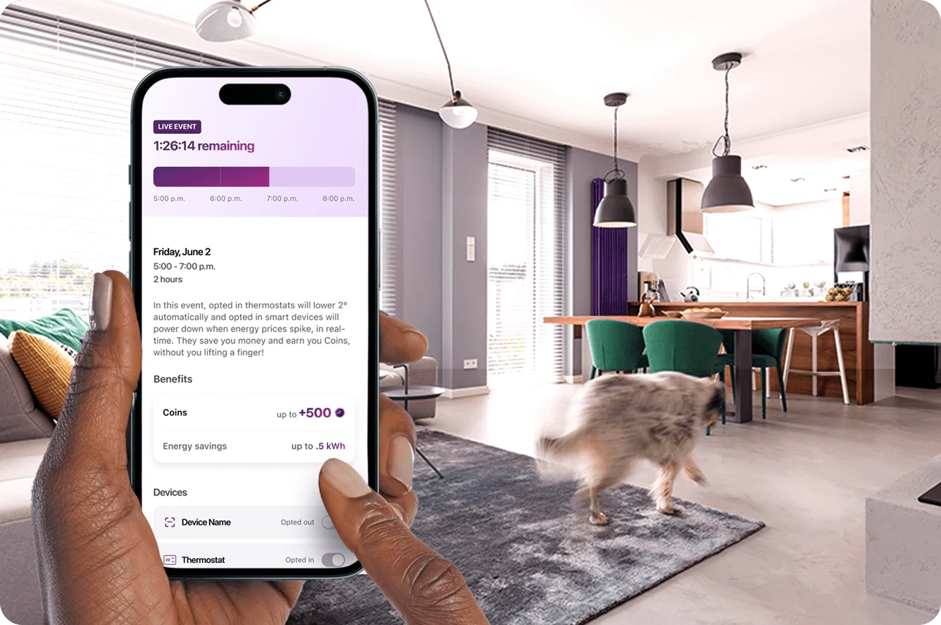 Hand holding smartphone showing energy rewards app with modern living room background