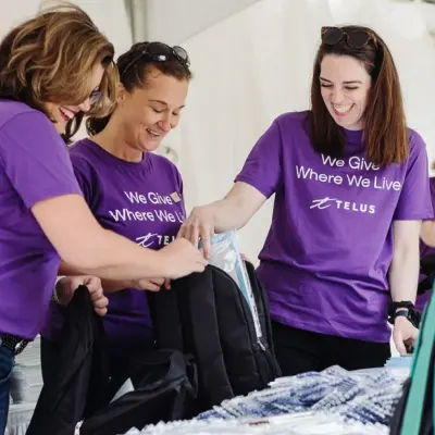 Volunteers packing backpacks
