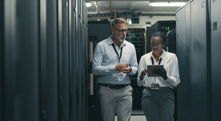 IT professionals managing infrastructure operations in data center server room.