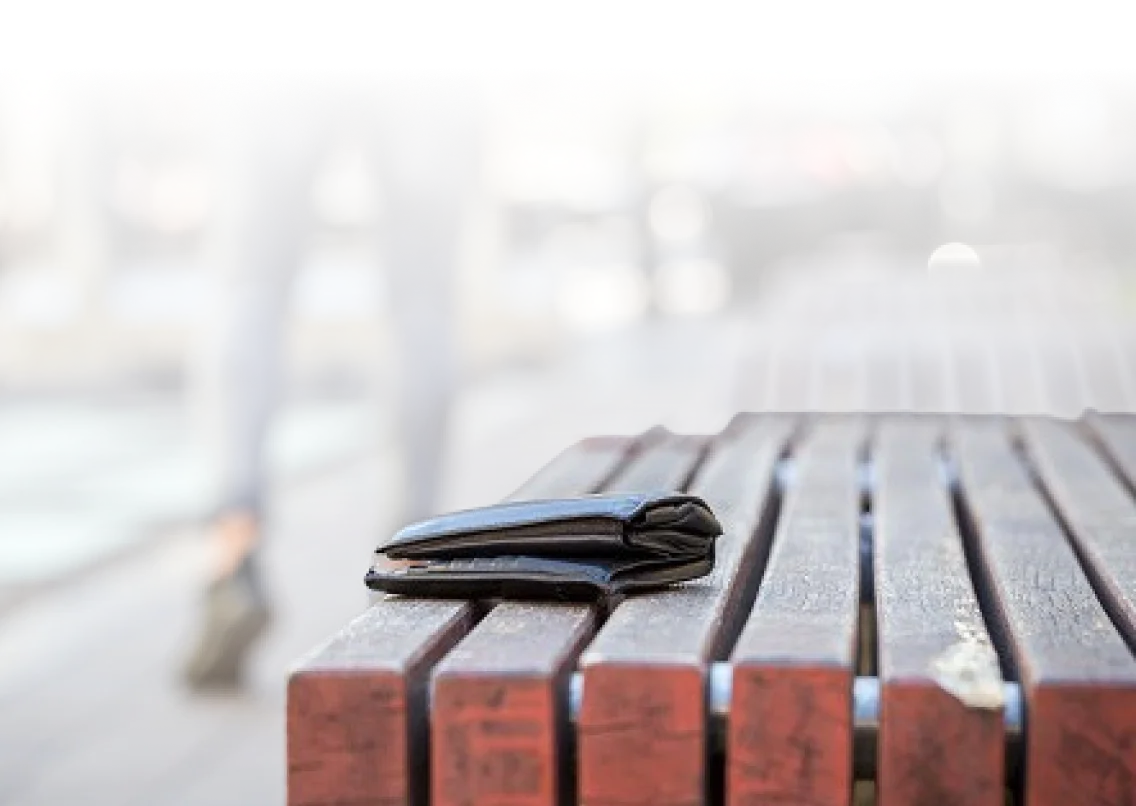 A wallet left on the edge of a table.