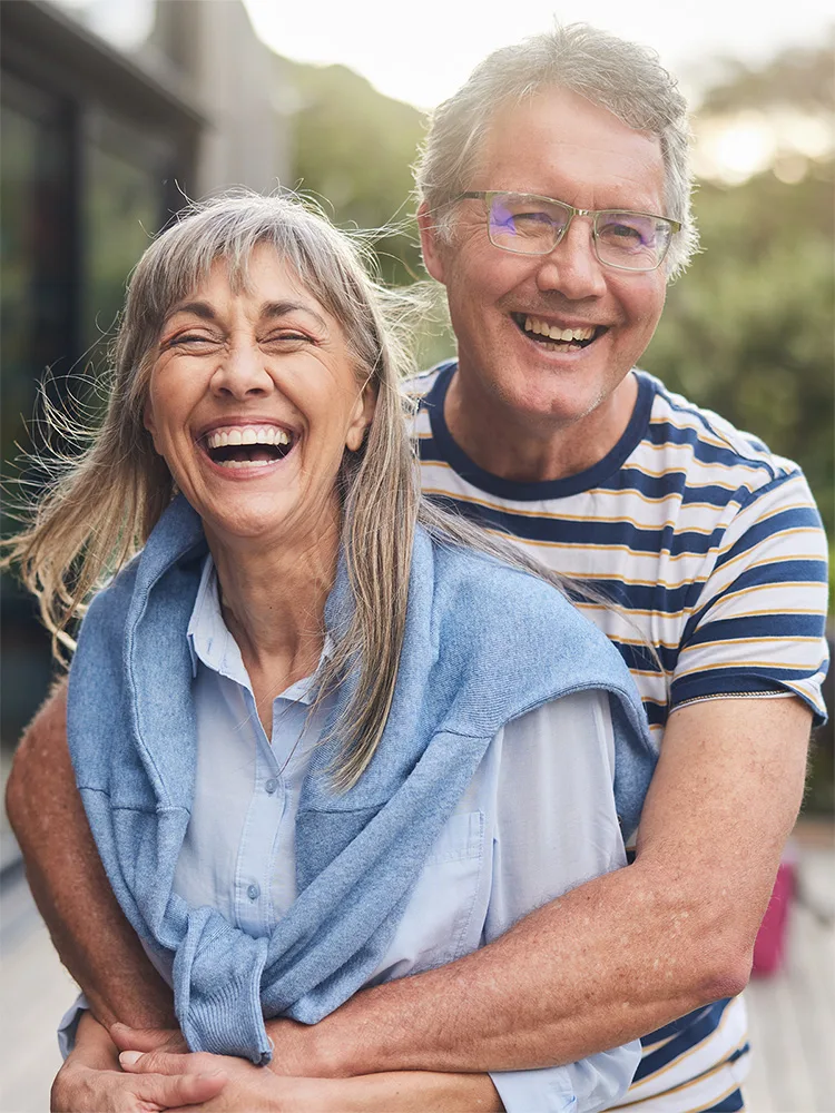 A happy couple embracing outside