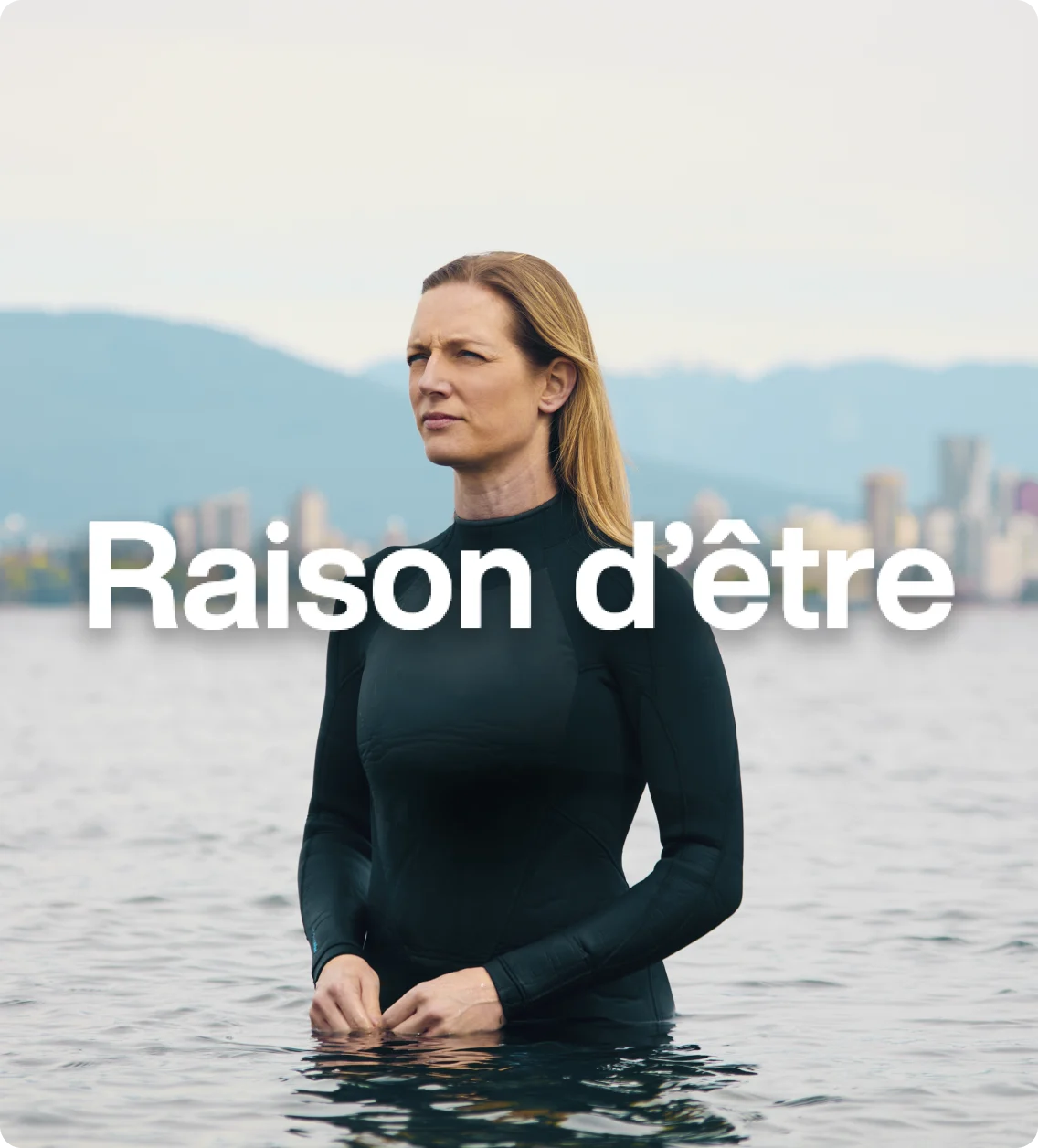 Carlyn Loncaric en scaphandre, debout dans l’eau, sur fond d’horizon avec le mot « détermination » en surimpression