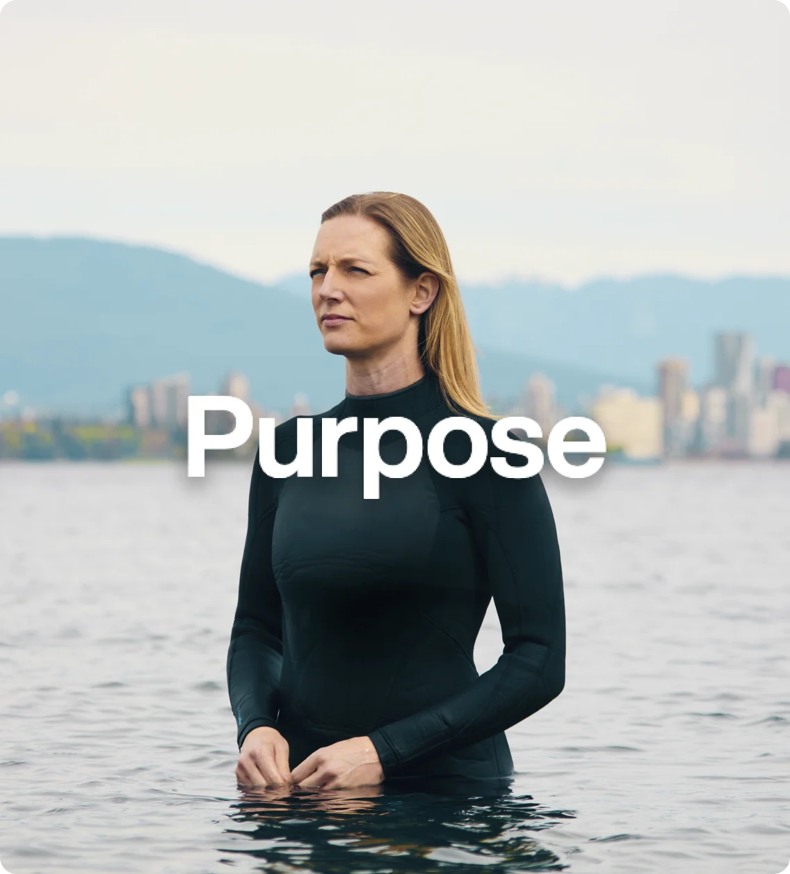 Carlyn Loncaric wearing scuba suit standing in water against skyline overlaid with word “purpose”