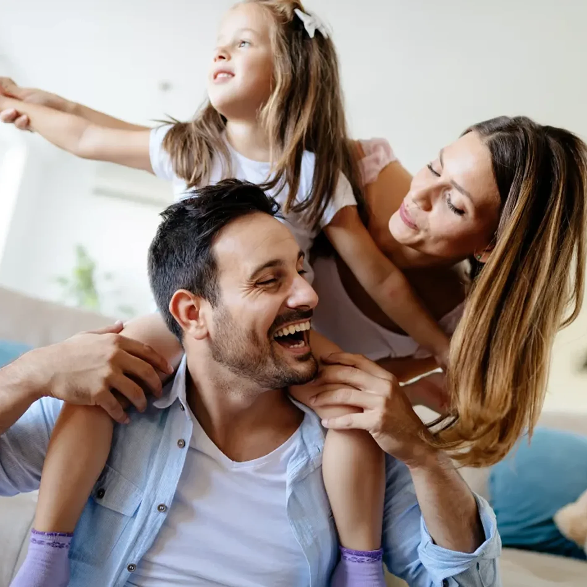 A happy family laughing together, representing supportive care and family well-being.