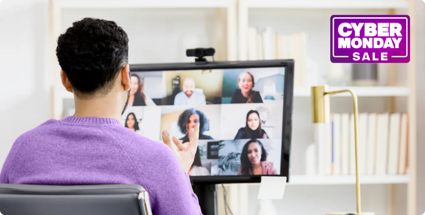 Three business people using their tablest and a monitor, connected in a meeting through fast fibre with a Cyber Monday sale badge.