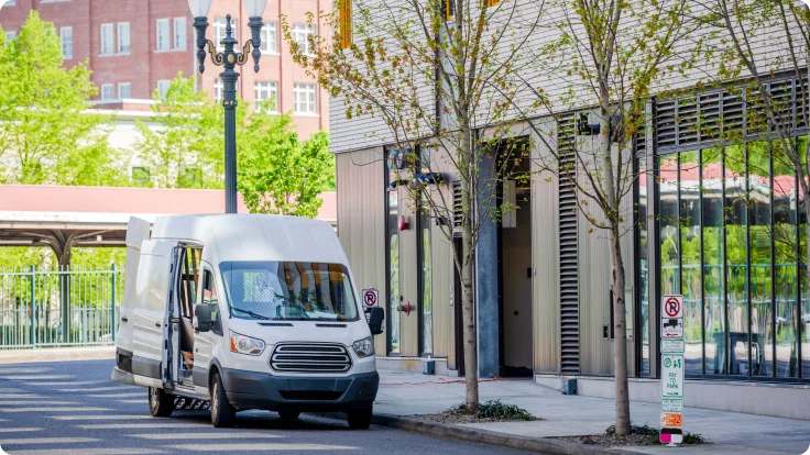 White van parked on street to make a delivery