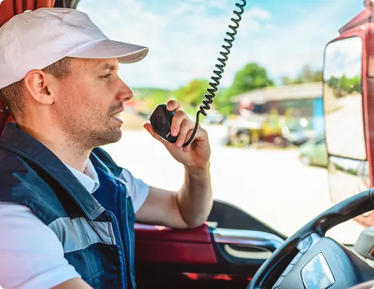 Delivery driver using mobile radio communication in vehicle.