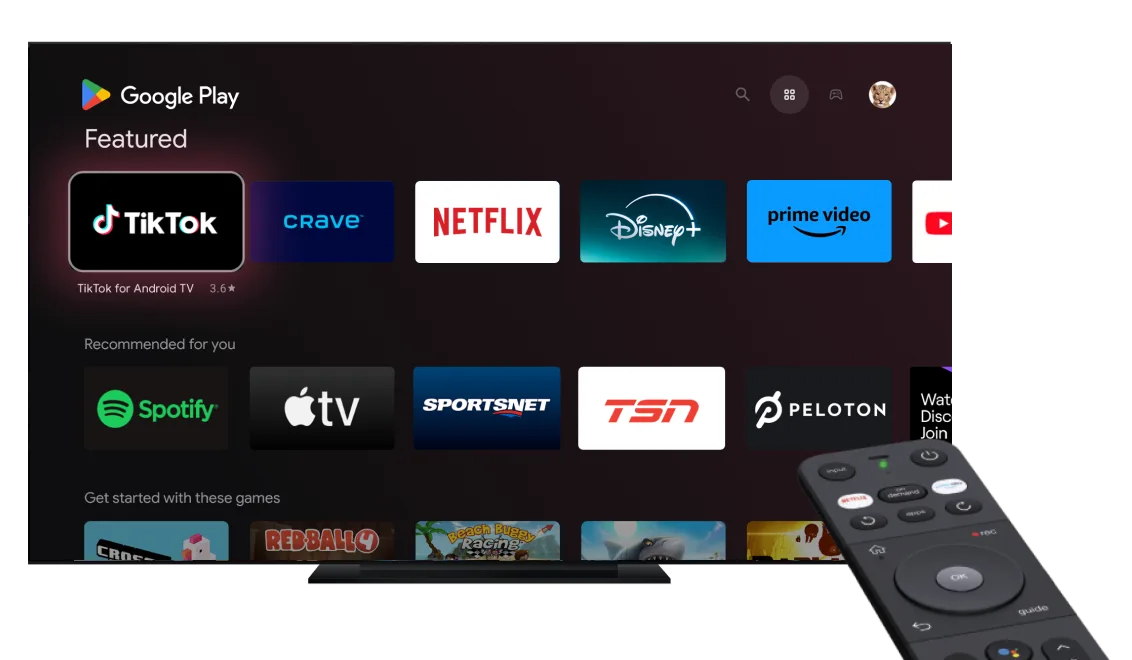 A large smart TV with various streaming apps displayed on screen with a smart TV remote pointing towards it