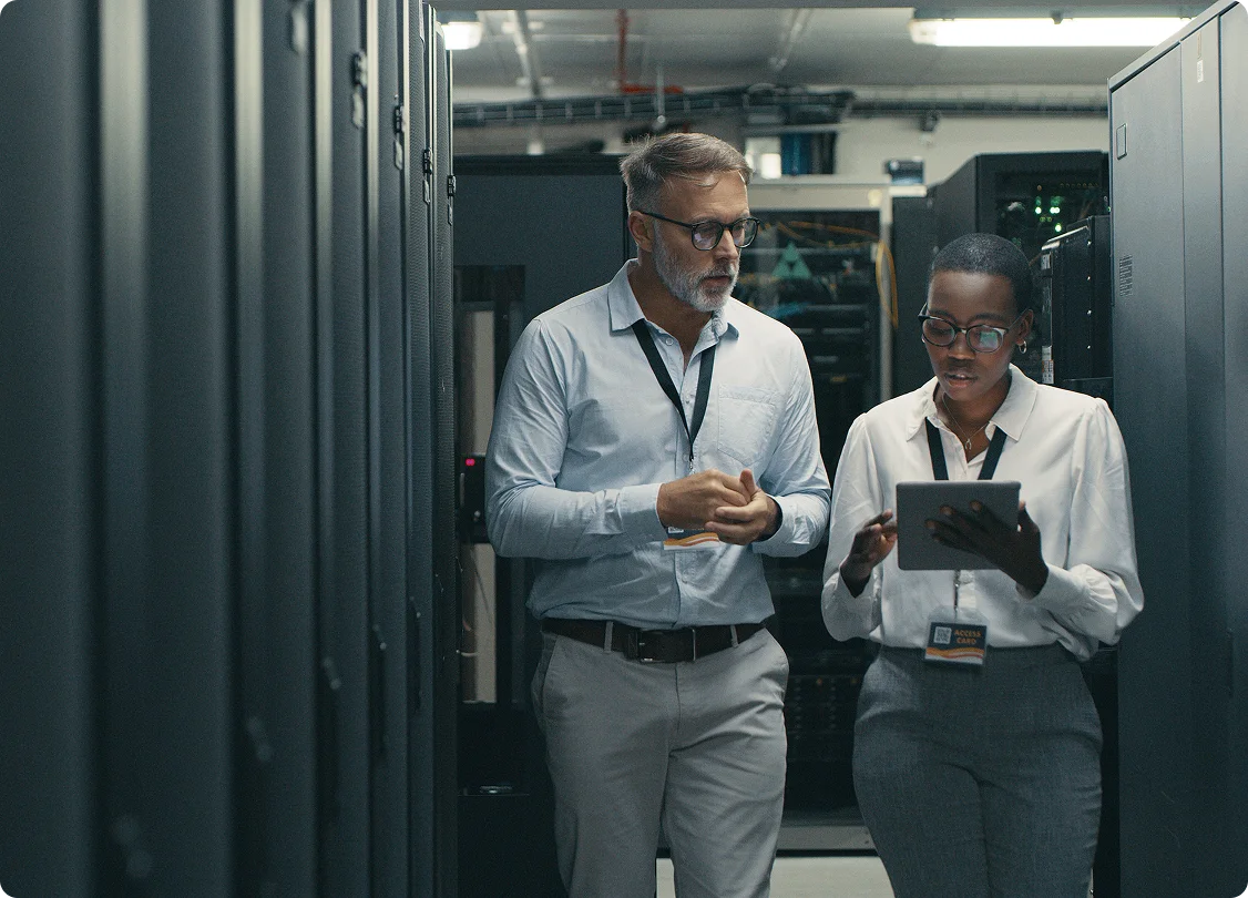 IT professionals discussing work in server room