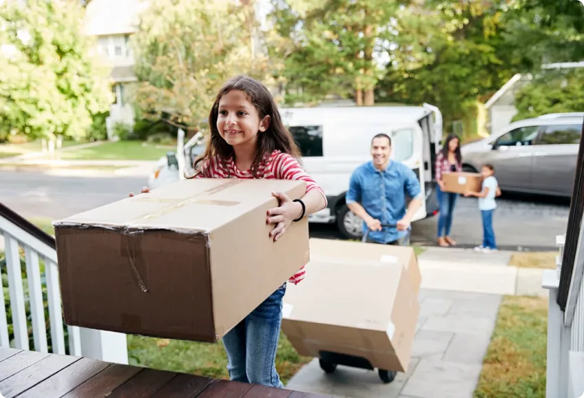 A family moving their belongings into their new home